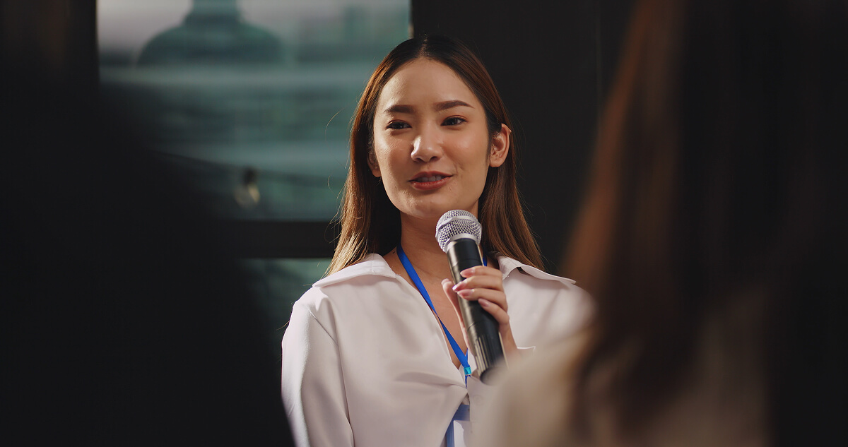 Speaker holding a microphone