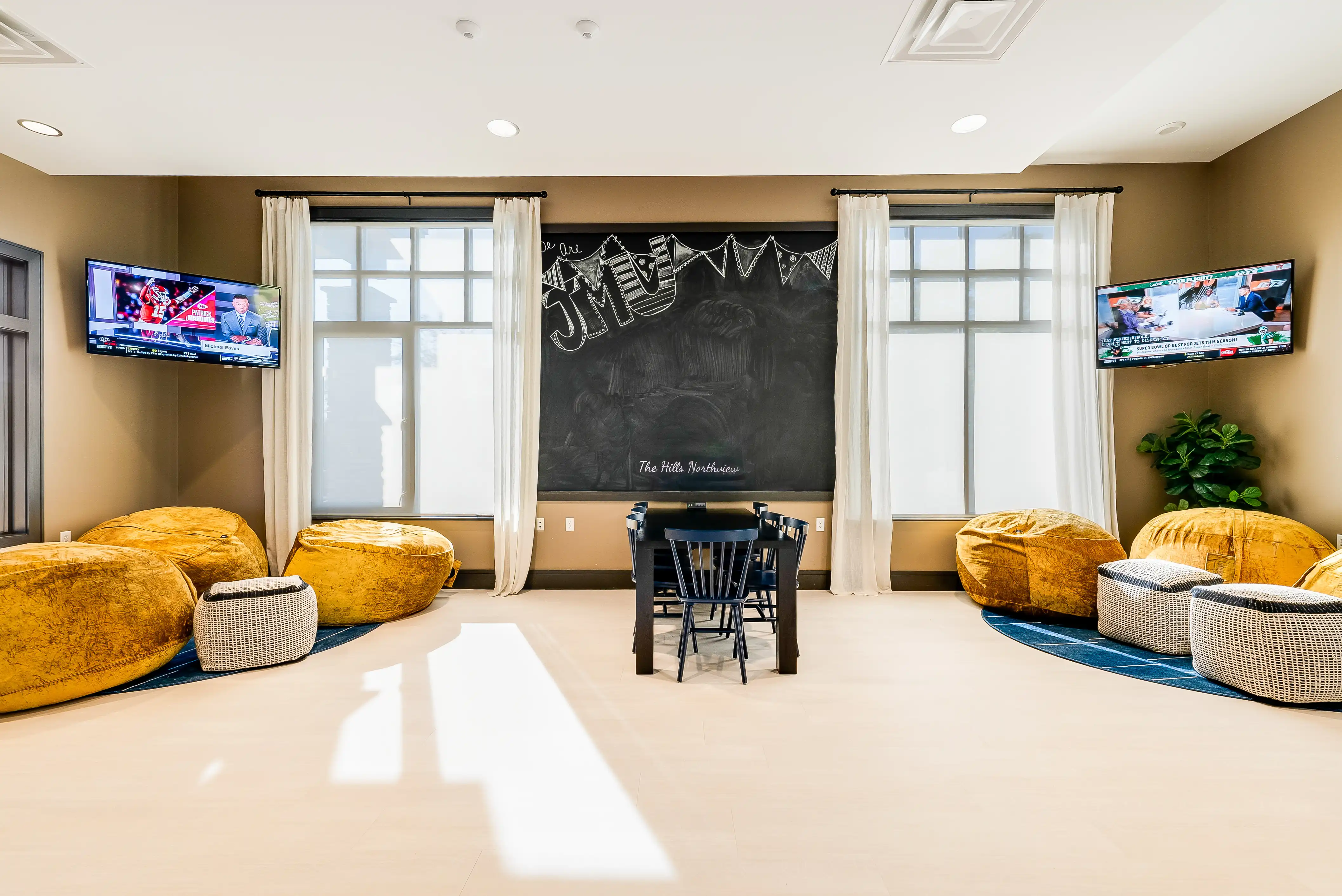 Resident lounge with bean bag chairs and TVs