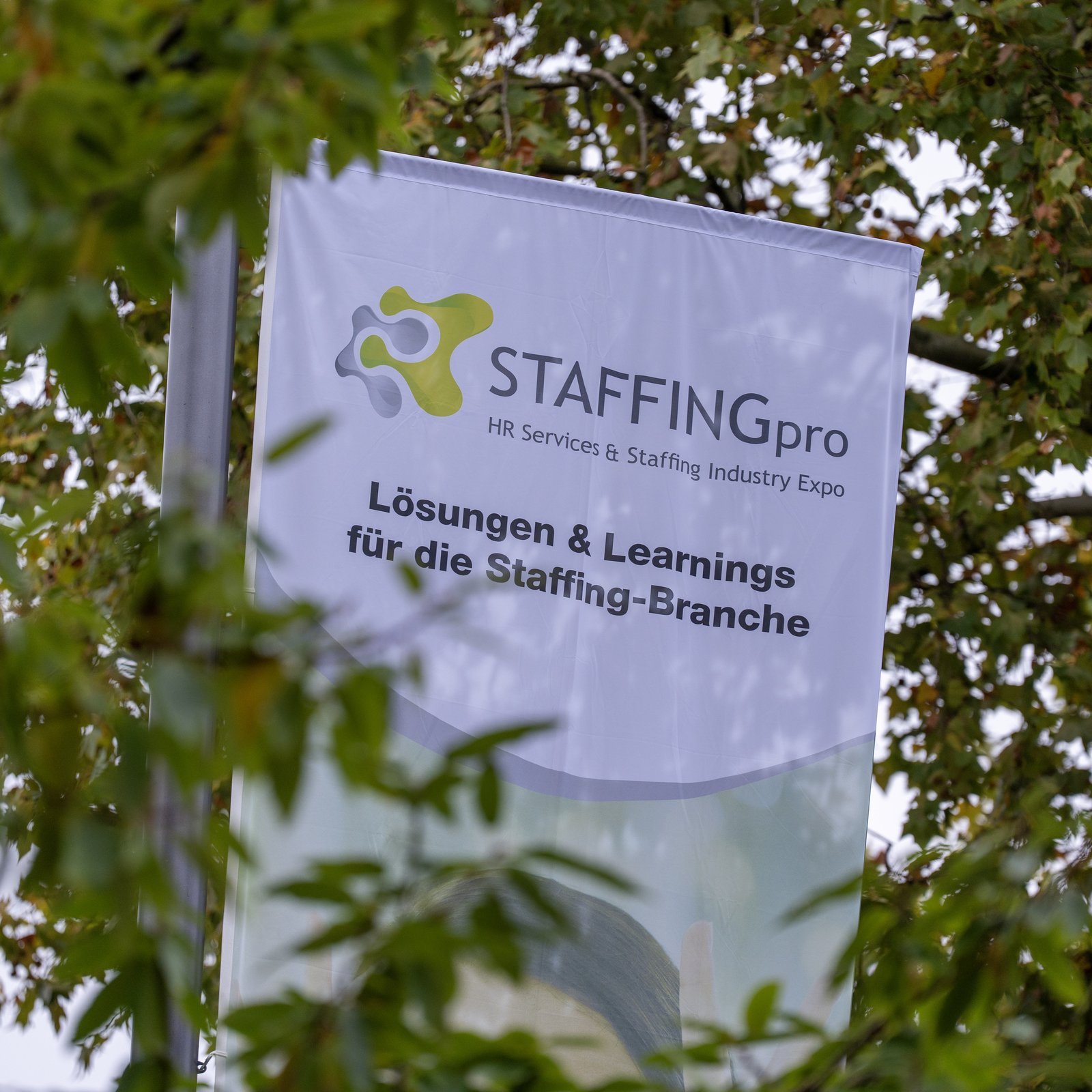 STAFFINGpro flag among autumn trees outside the RheinMain CongressCenter in Wiesbaden