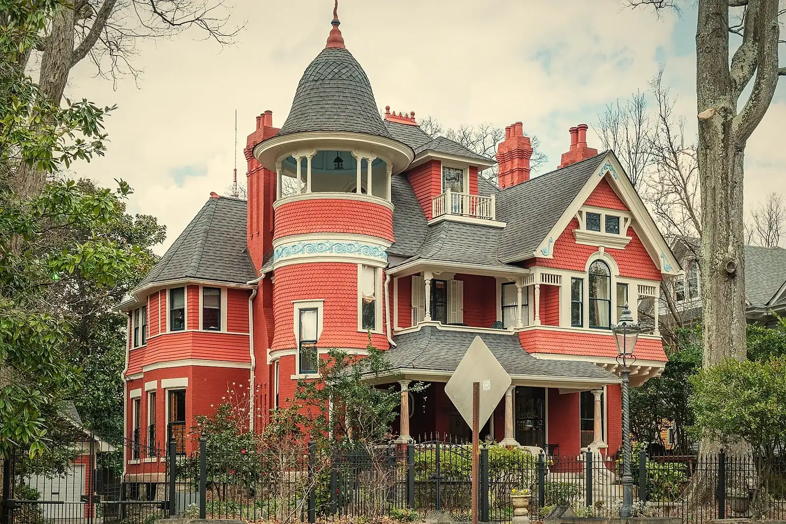 A Queen Anne Victorian house with a turret and wraparound porch in Atlanta’s Inman Park neighborhood