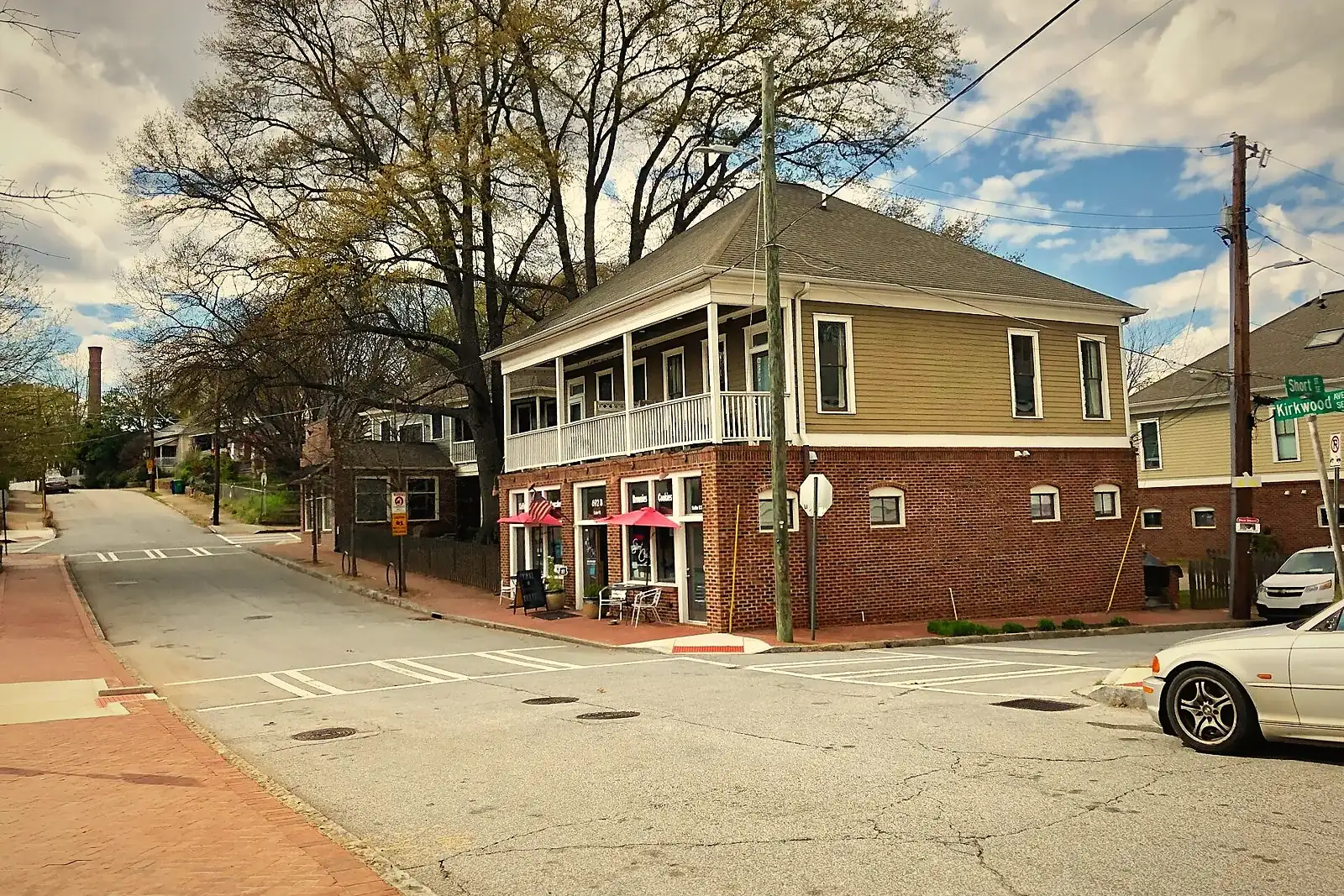 A two-story home with a second-floor porch on a street corner in Atlanta’s Cabbagetown neighborhood