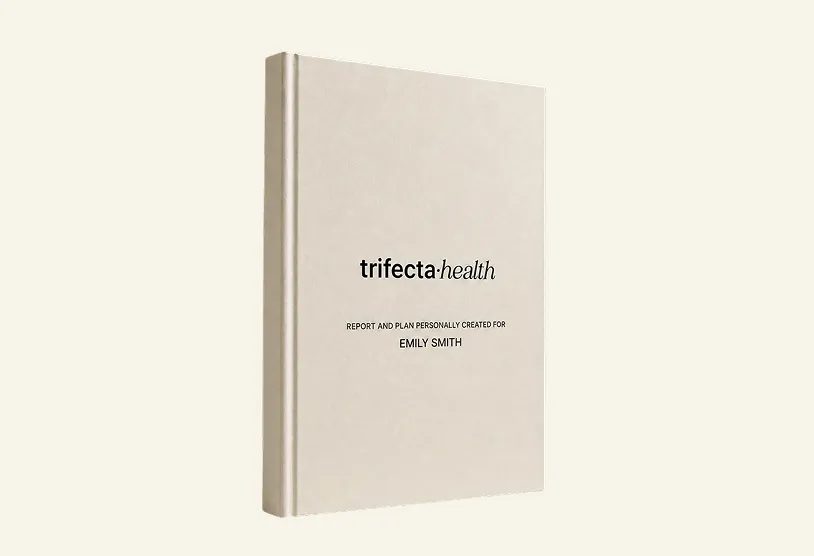 Closed beige book titled 'trifecta health' with subtitle 'Report and plan personally created for Emily Smith' on the cover.