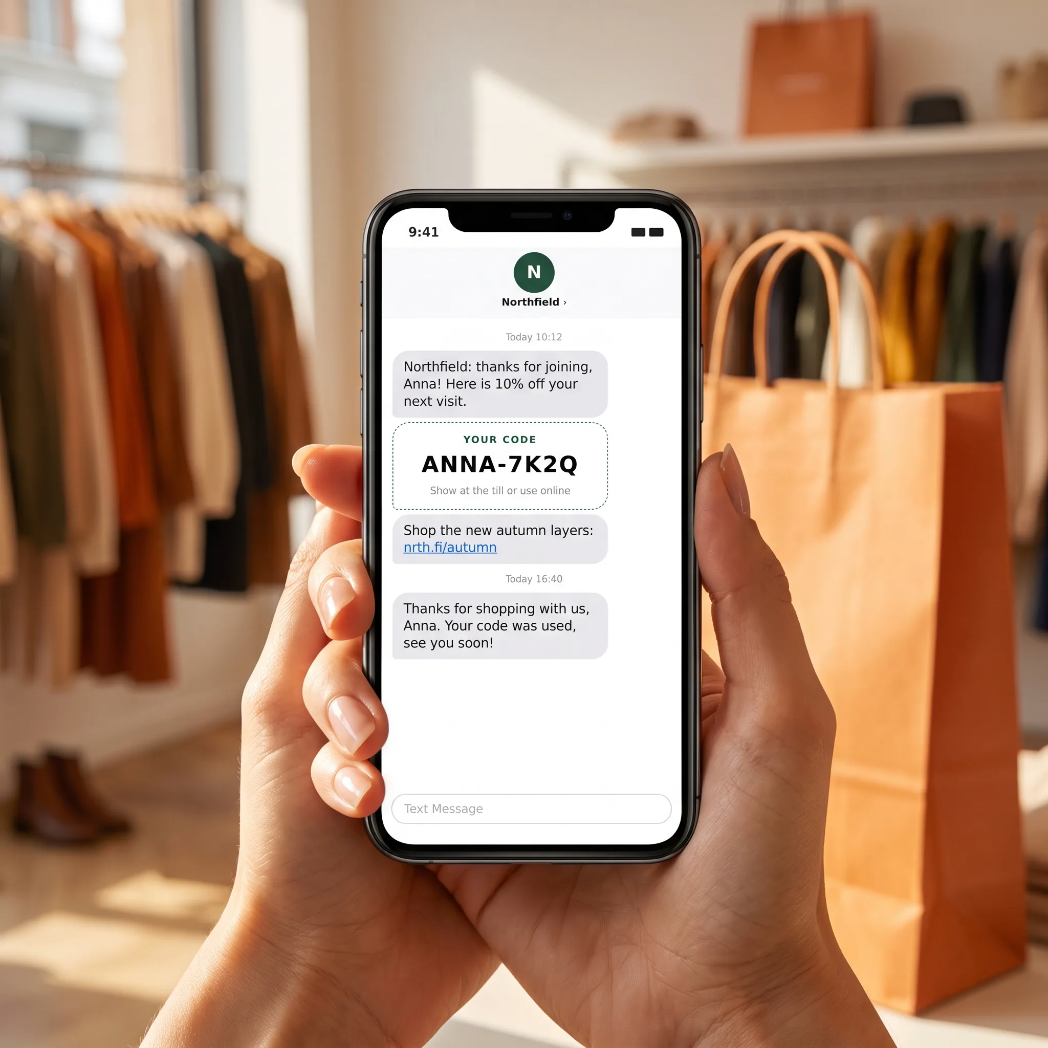 Phone showing a store discount code sent by SMS, with a verified sign-up and a redeemed code