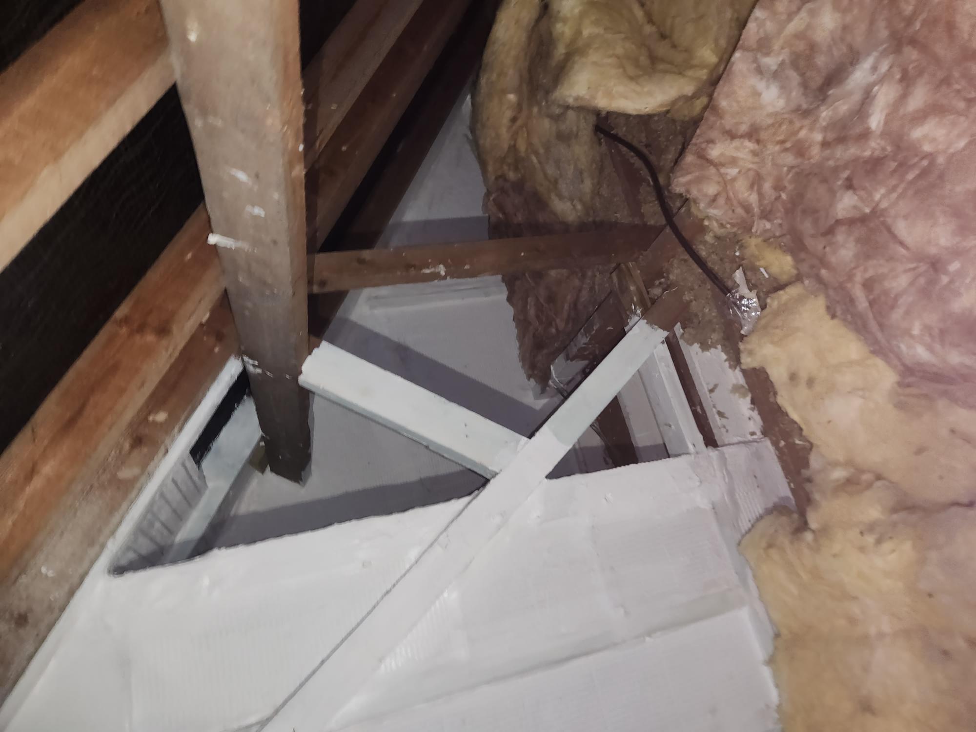 Passive fire protection boarding fitted around timber roof structure in a loft