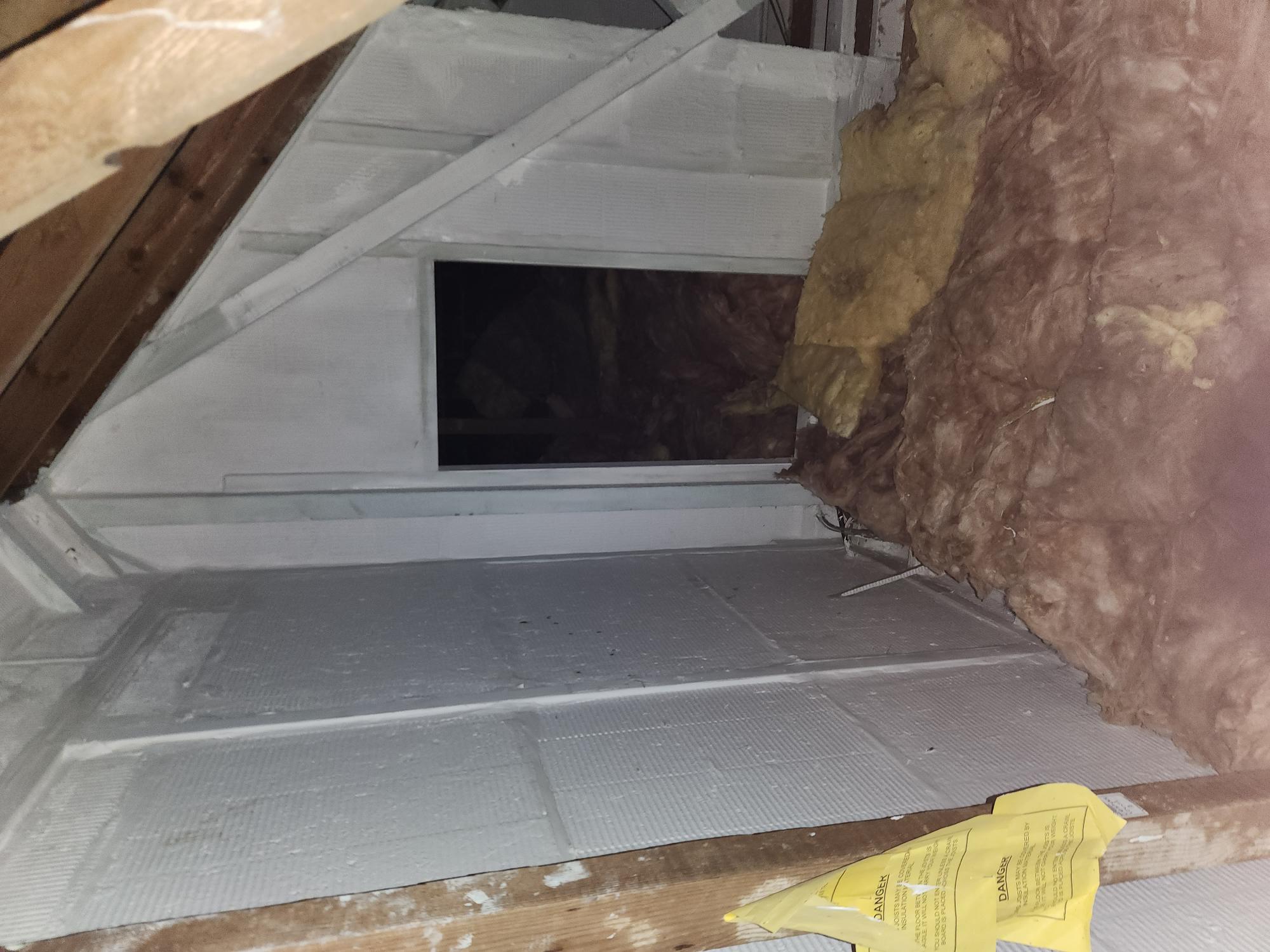 Fire barrier boarding sealing a roof void to stop fire and smoke spread between properties