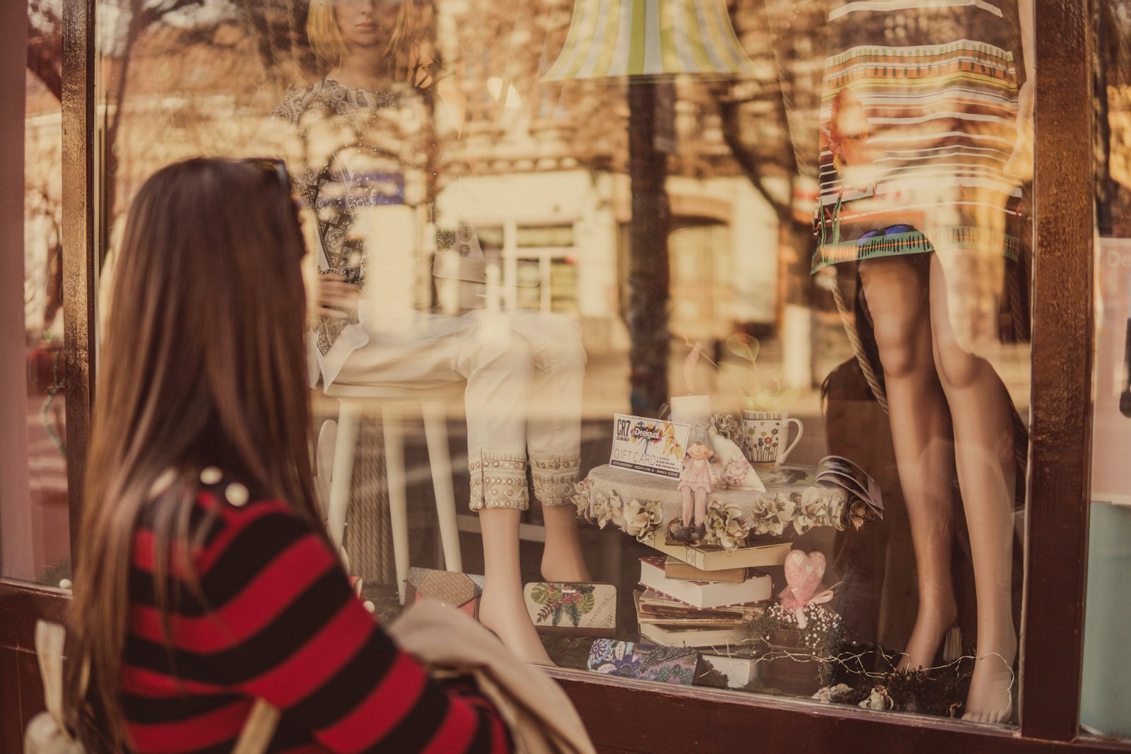Shopper looking at a mannequin in a shop window