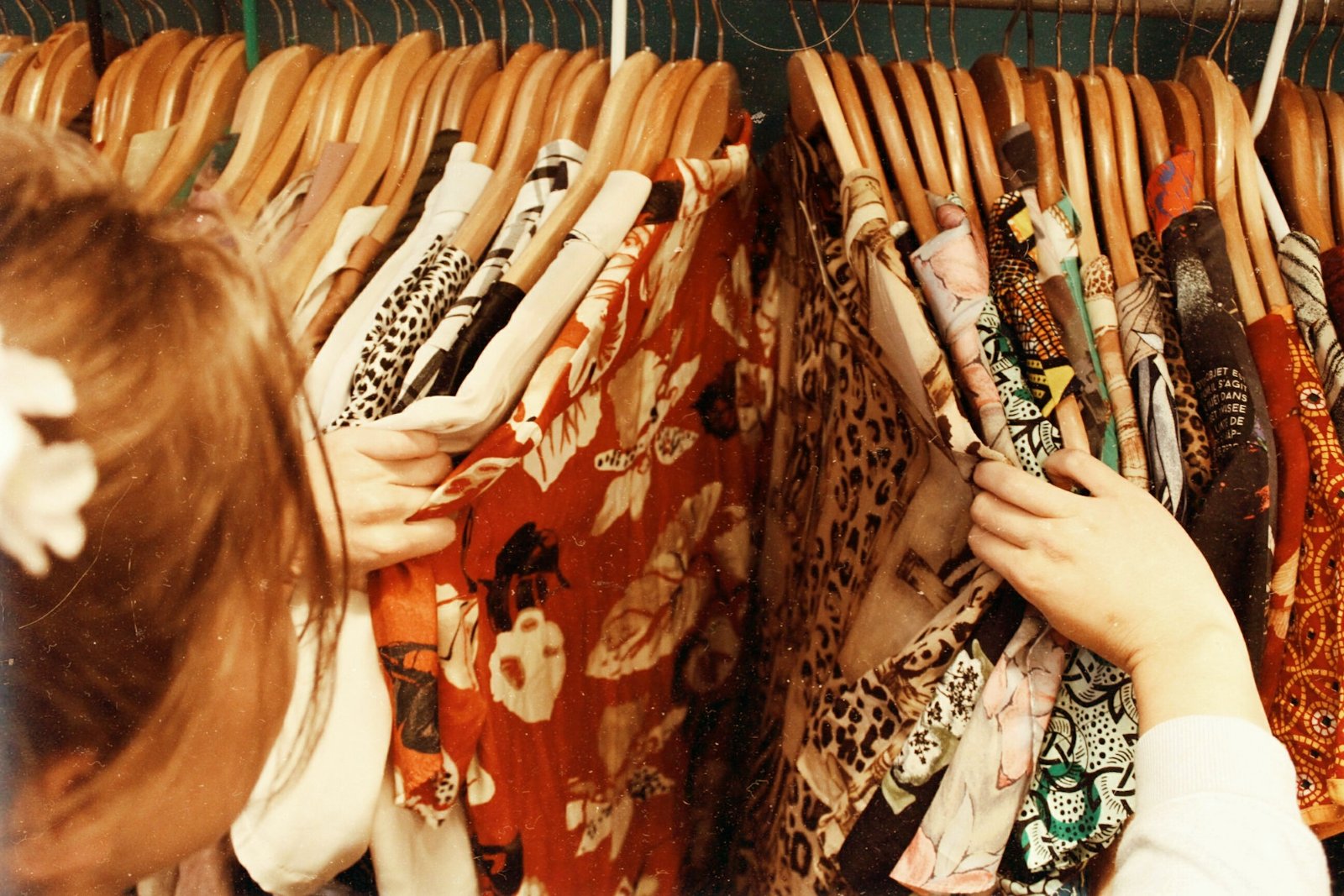 Shopper browsing patterned clothes on a rack