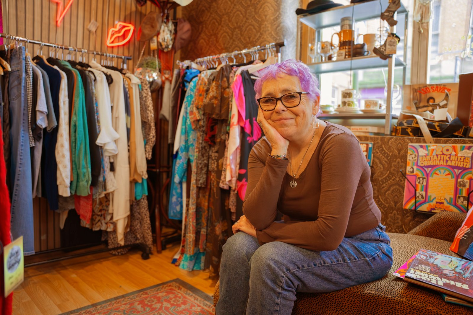 Boutique owner sitting in her clothing store
