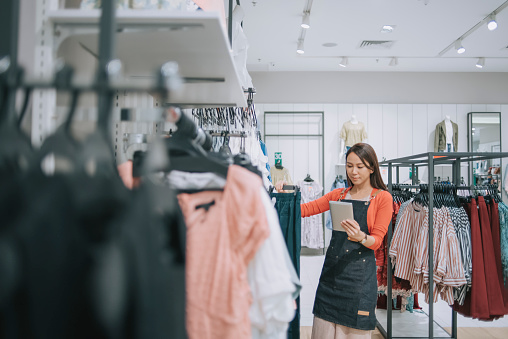 Retail adviser helping a customer in a clothing store