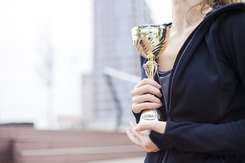 Business award winner holding a trophy