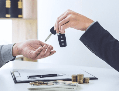 Customer receiving car keys after purchase