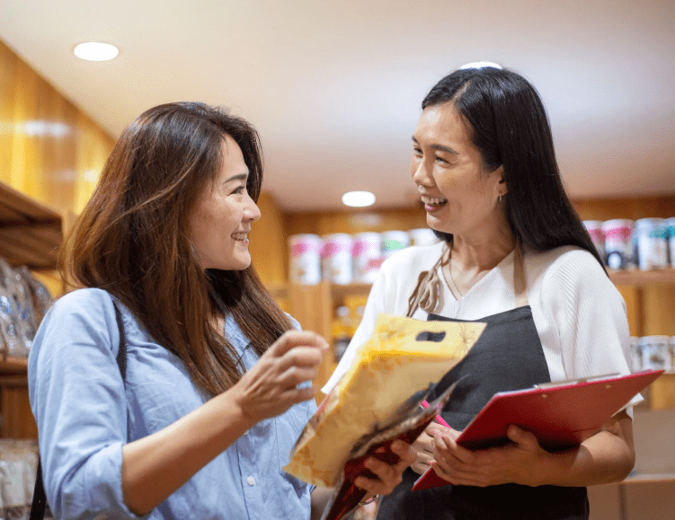 Retail assistant helping customer choose a product