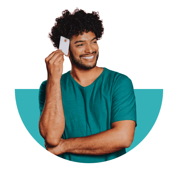 Smiling man holding a bank card up to his ear