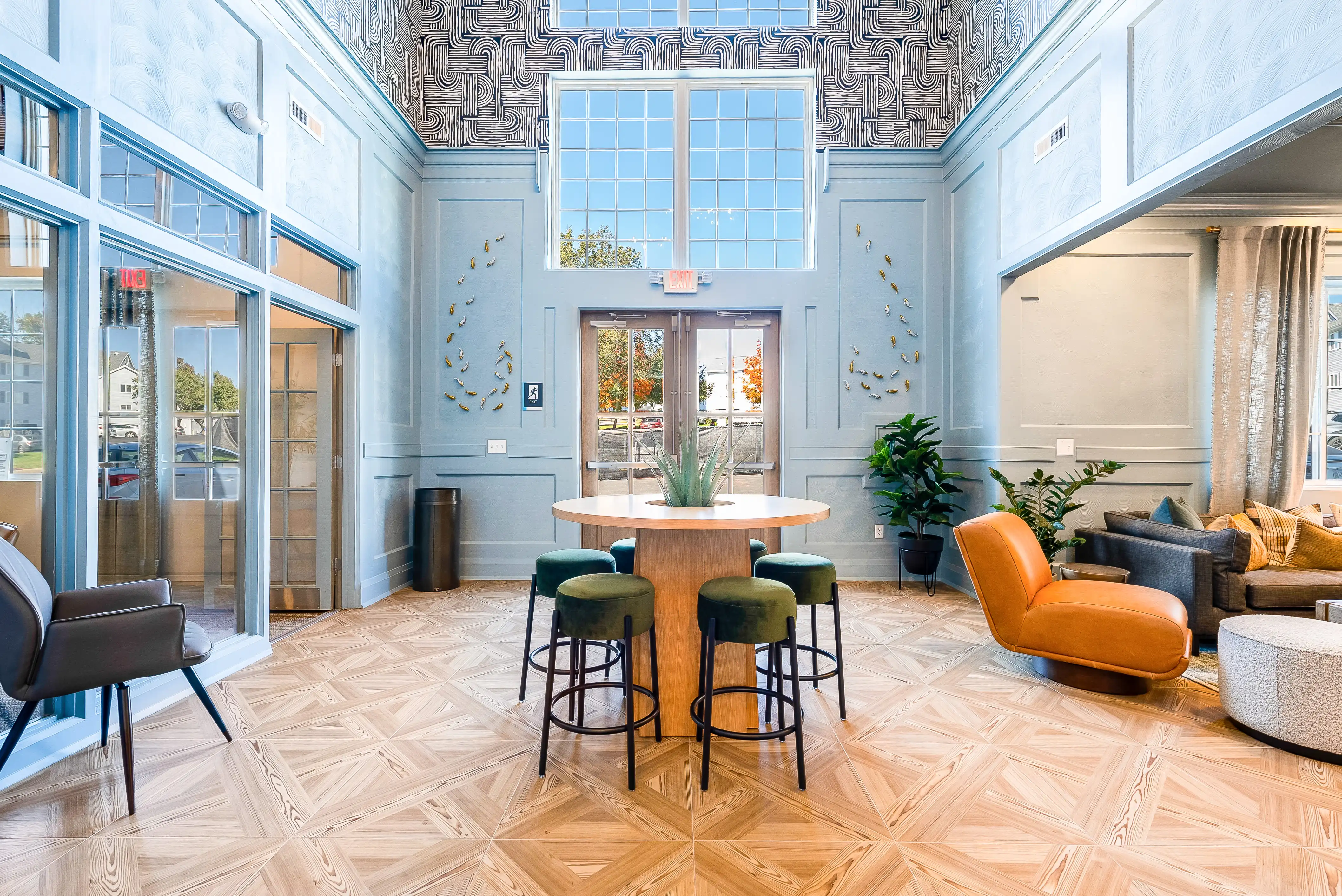 Clubhouse lounge with tables and soft seating at The Hills Southview