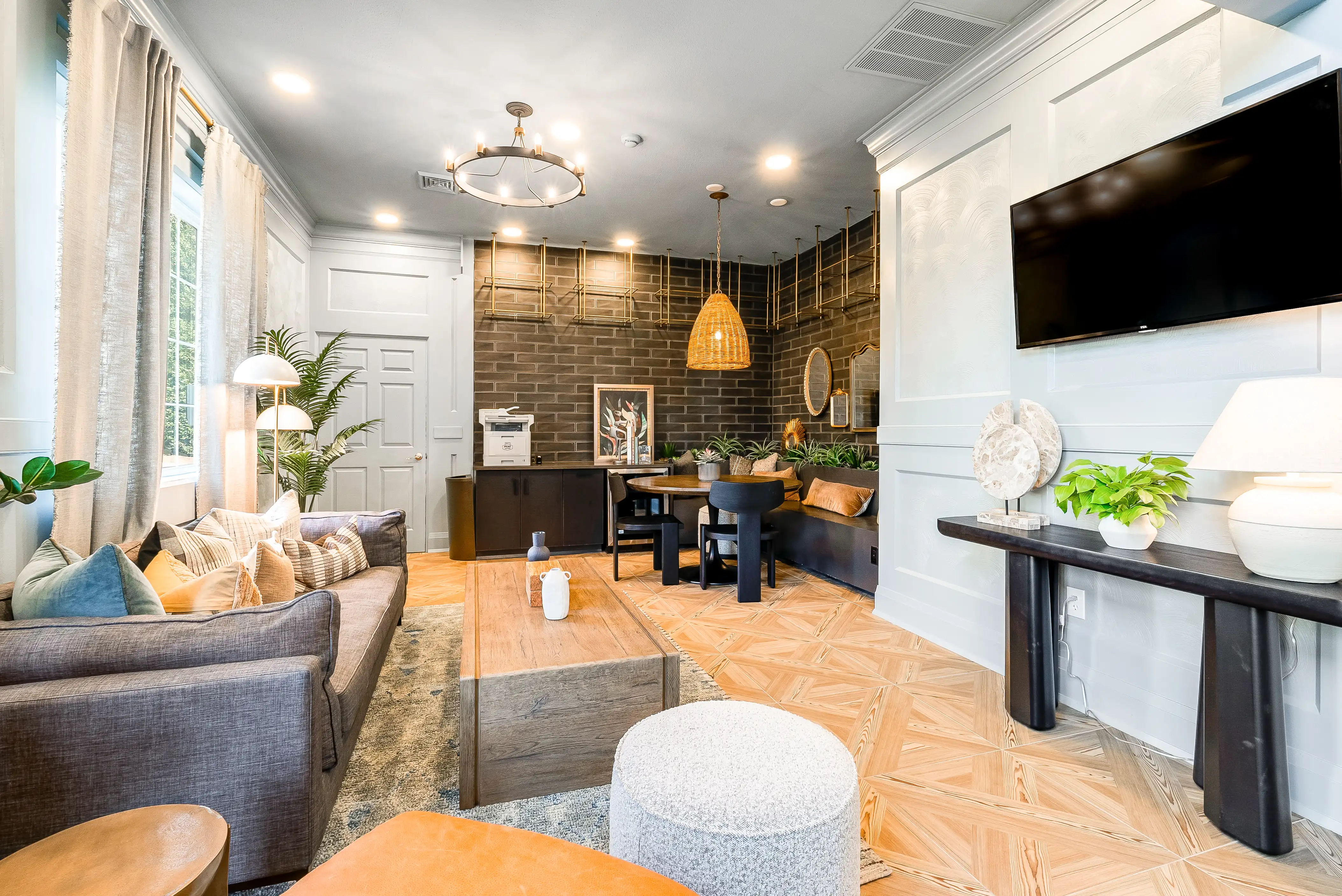 Resident lounge with TV and wood accent wall at The Hills Southview
