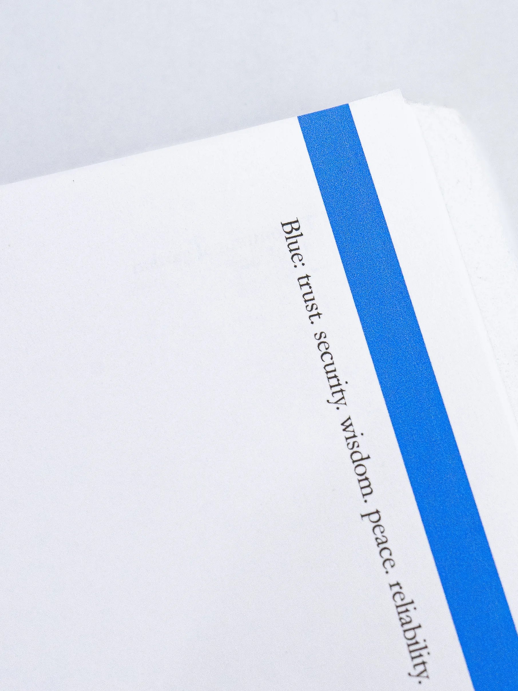 A page edge with a blue stripe and a line of printed words