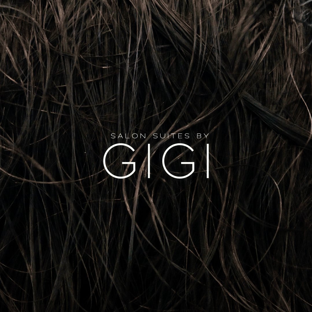 Salon Suites by GIGI wordmark in white over dark hair