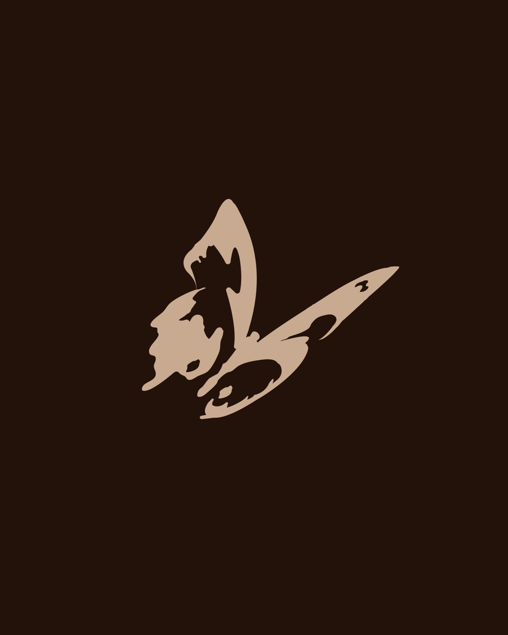The TRUST butterfly mark in sand on espresso