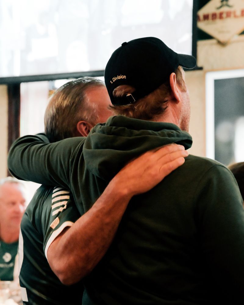 Two AB fans hugging after a goal