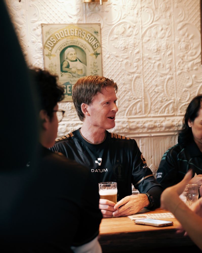 Fans at a table watching the match