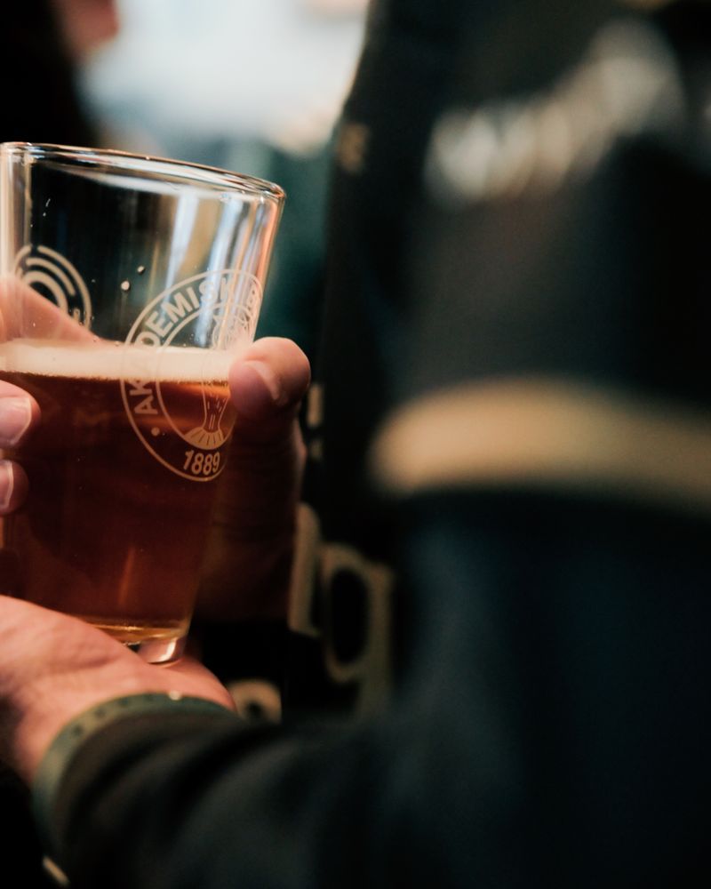 A raised pint at the bar