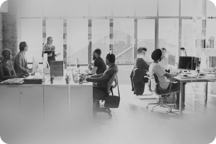 An open-plan workspace with people at their desks