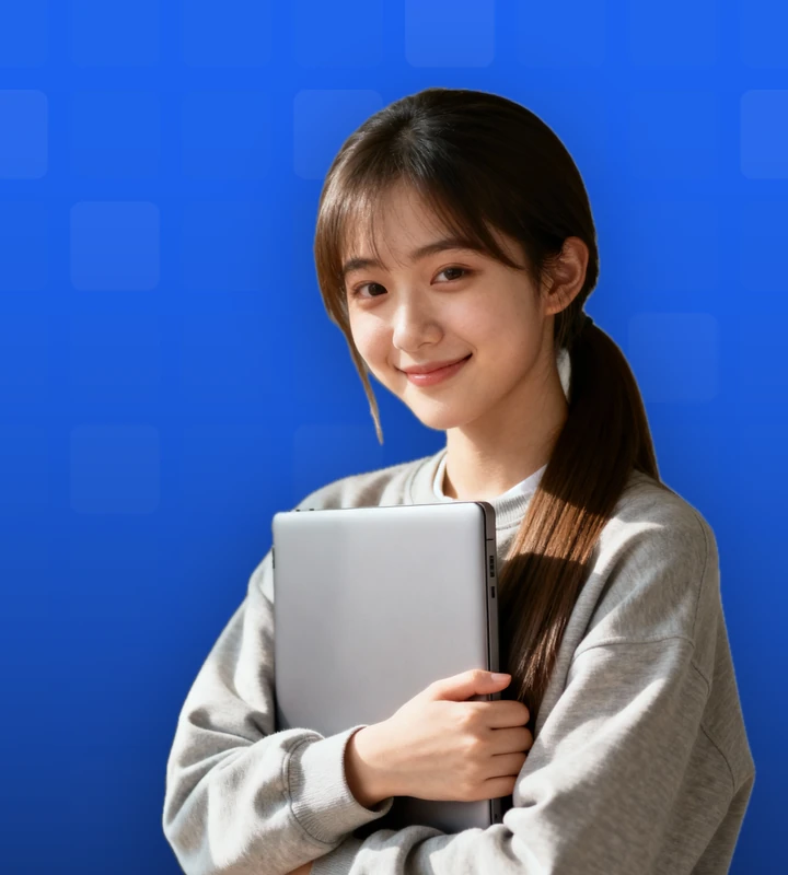 A smiling professional holding a laptop