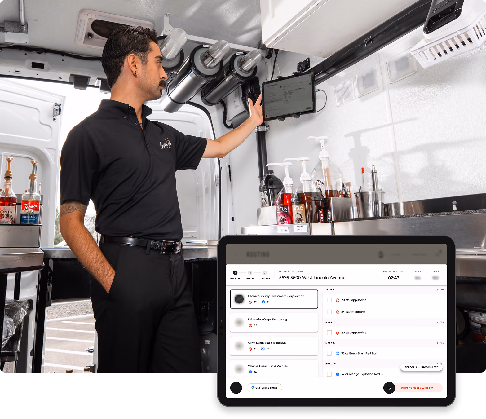 A man wearing a black polo shirt stands inside a mobile workspace, interacting with a mounted touchscreen device on the wall. In front, an inset screen shows a digital interface with a list of delivery tasks and order details including item names and quantities.