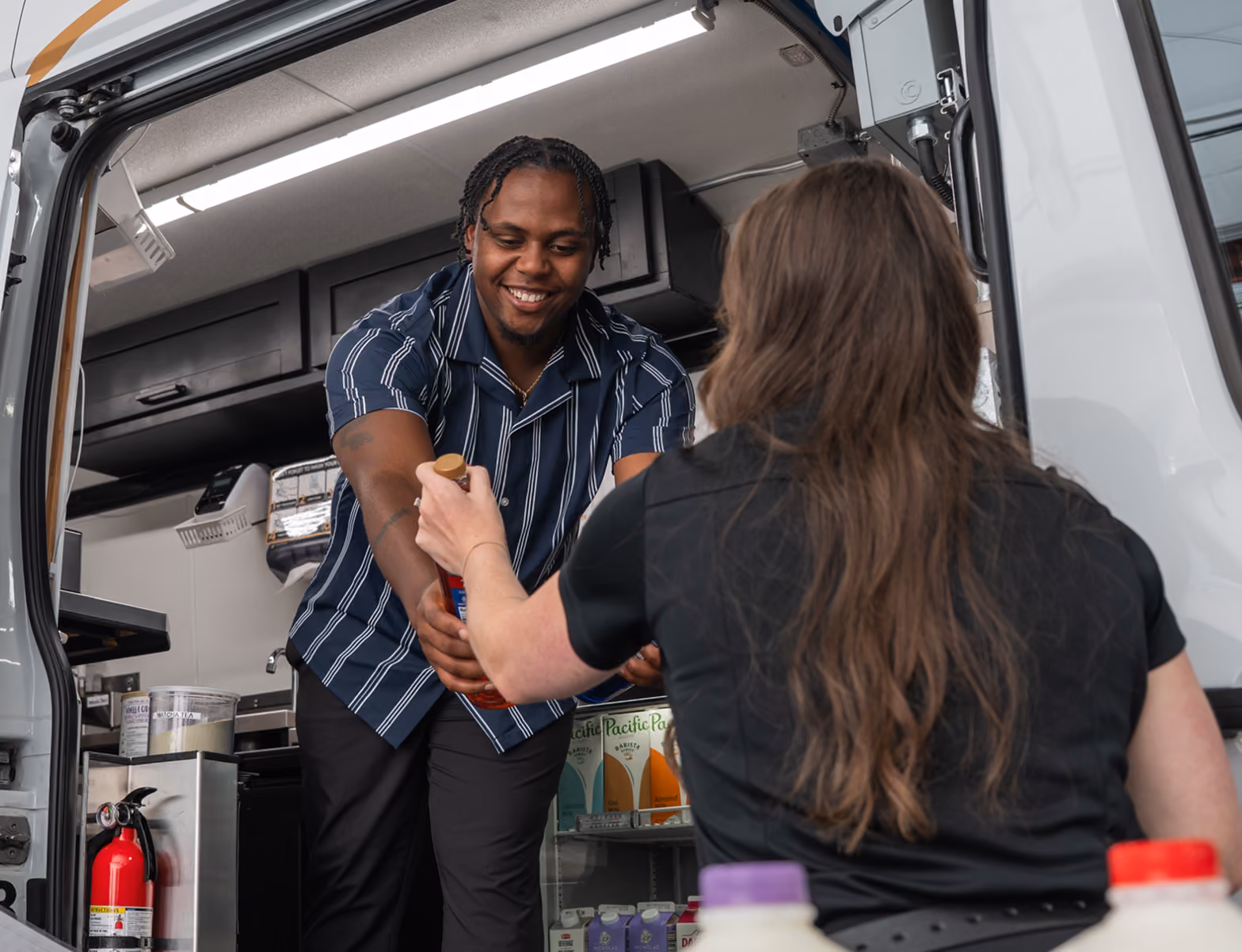 A CoffeeNow franchisee learns how to stock a delivery van.