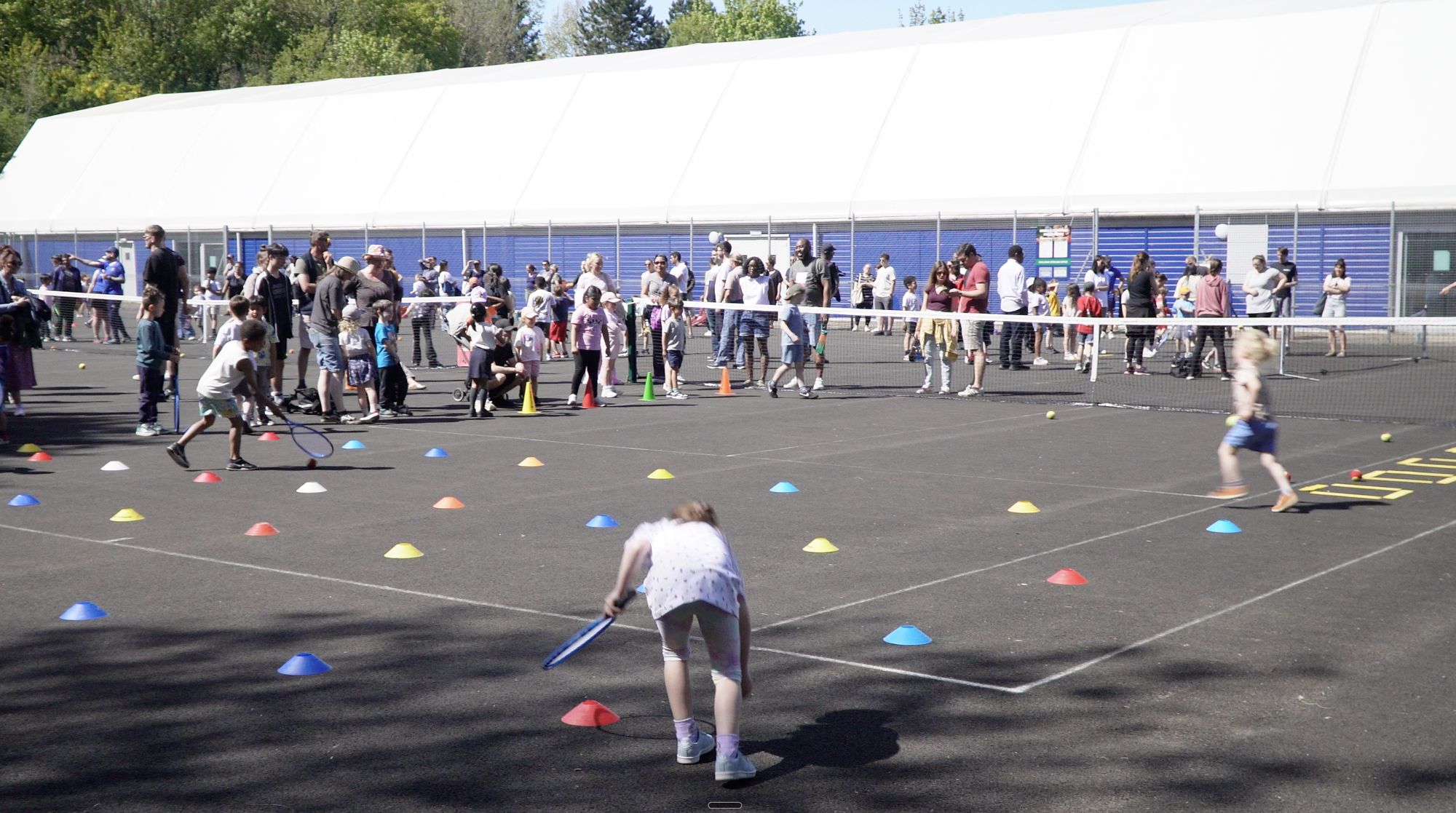 Children taking part in the Wimbledon Festival on the outdoor courts at War Memorial Park
