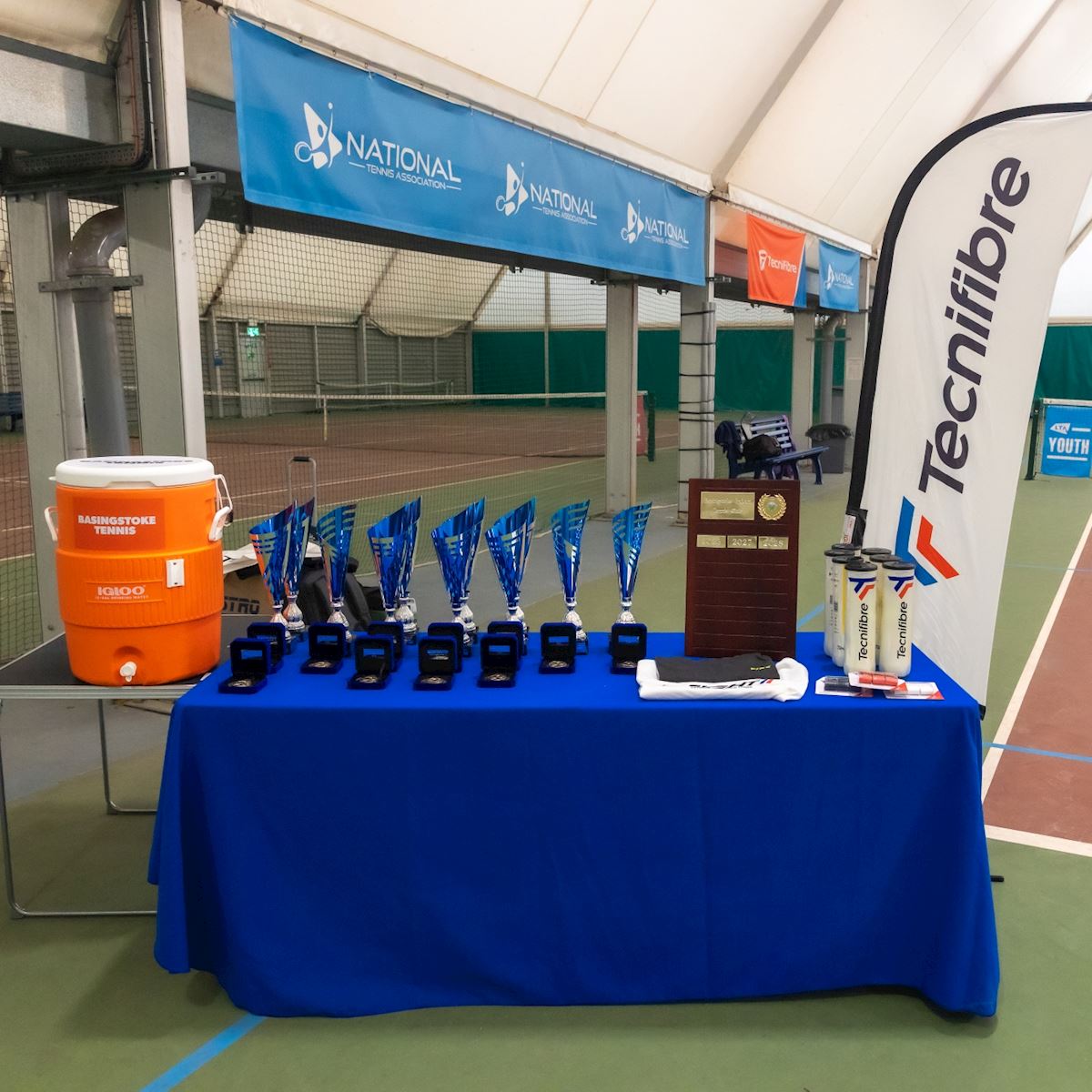The Club Championships trophies, medals and prizes laid out on a table in the indoor tennis centre