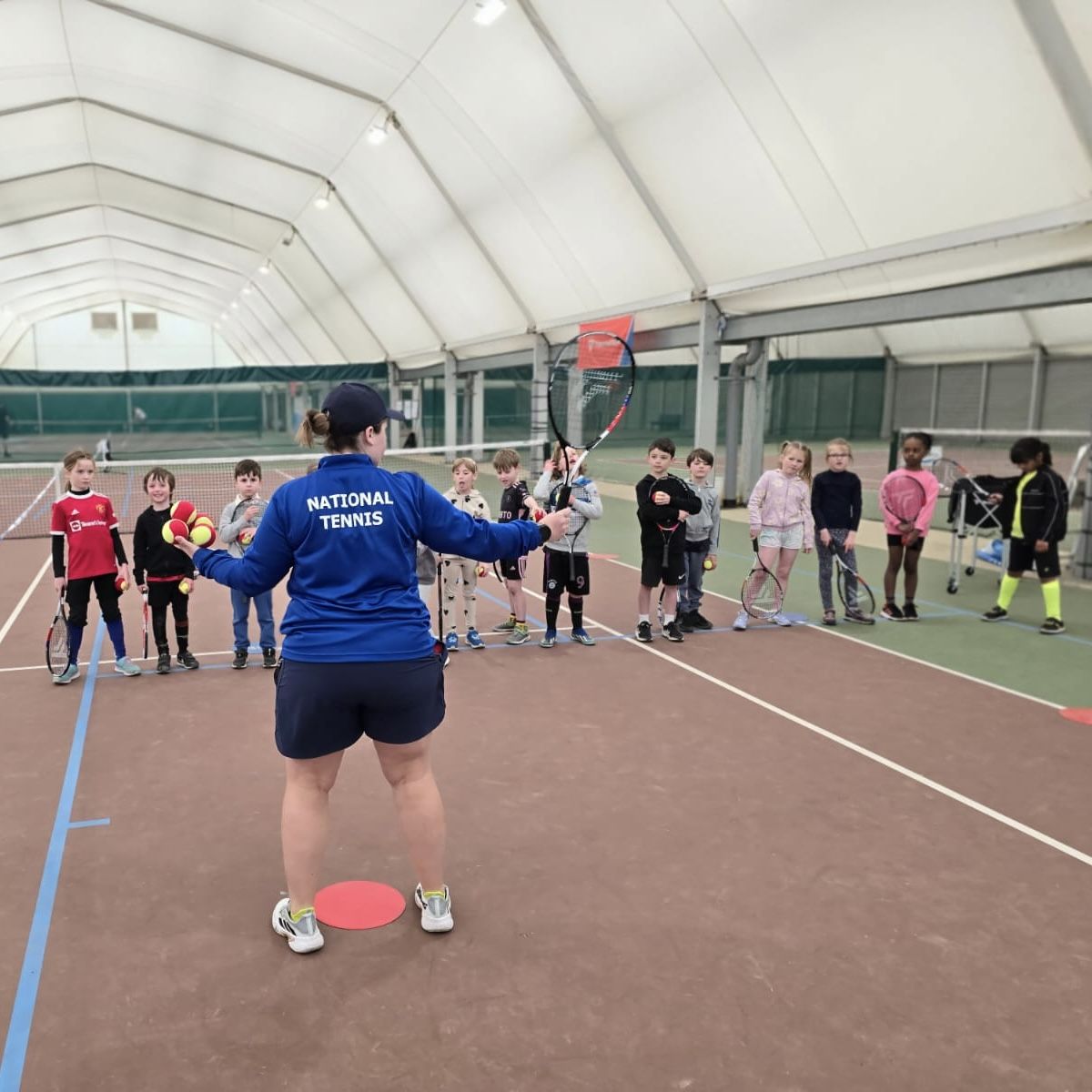 Coach running a youth class in the indoor hall at War Memorial Park