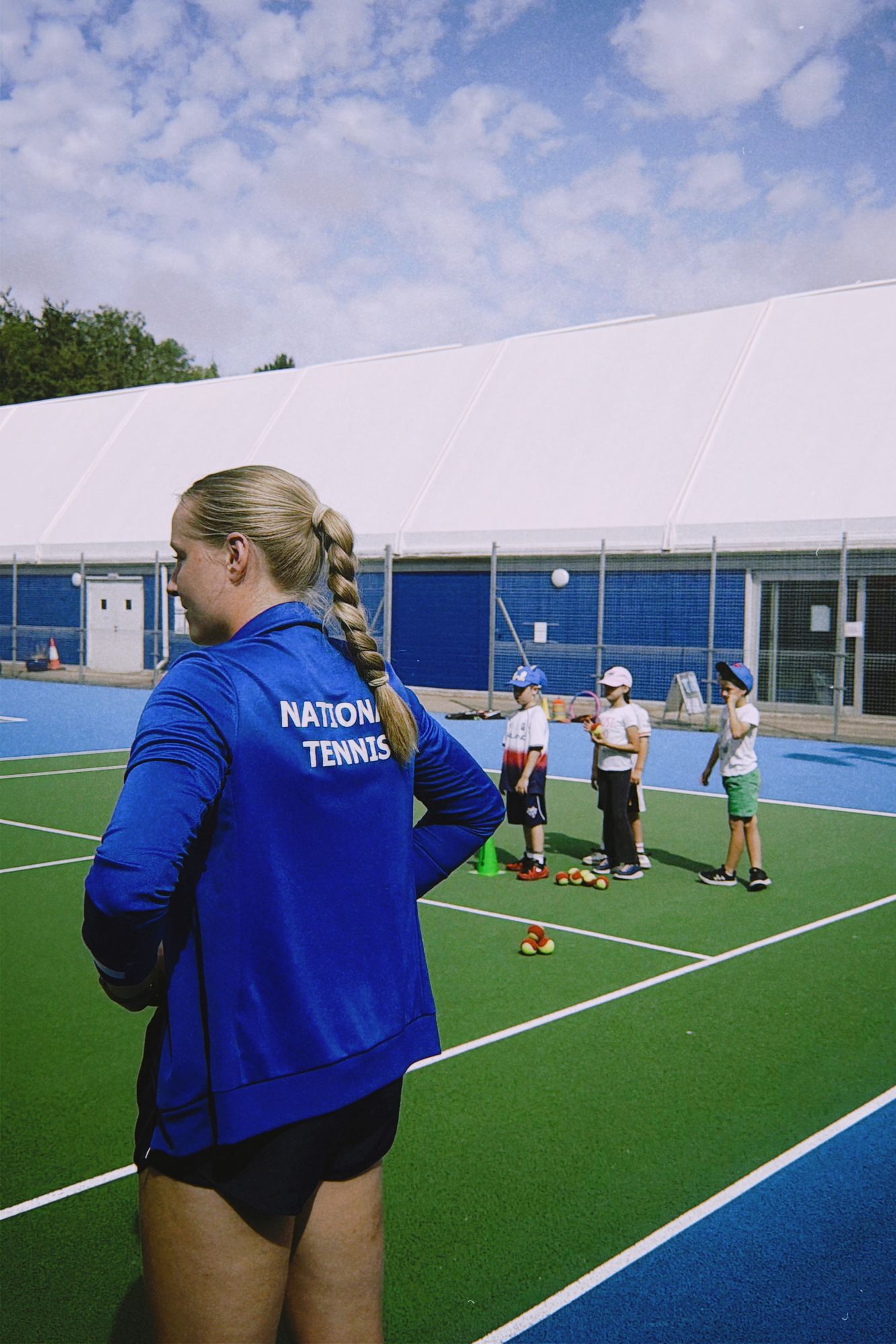 National Tennis coach with a holiday camp group on the outdoor courts at War Memorial Park
