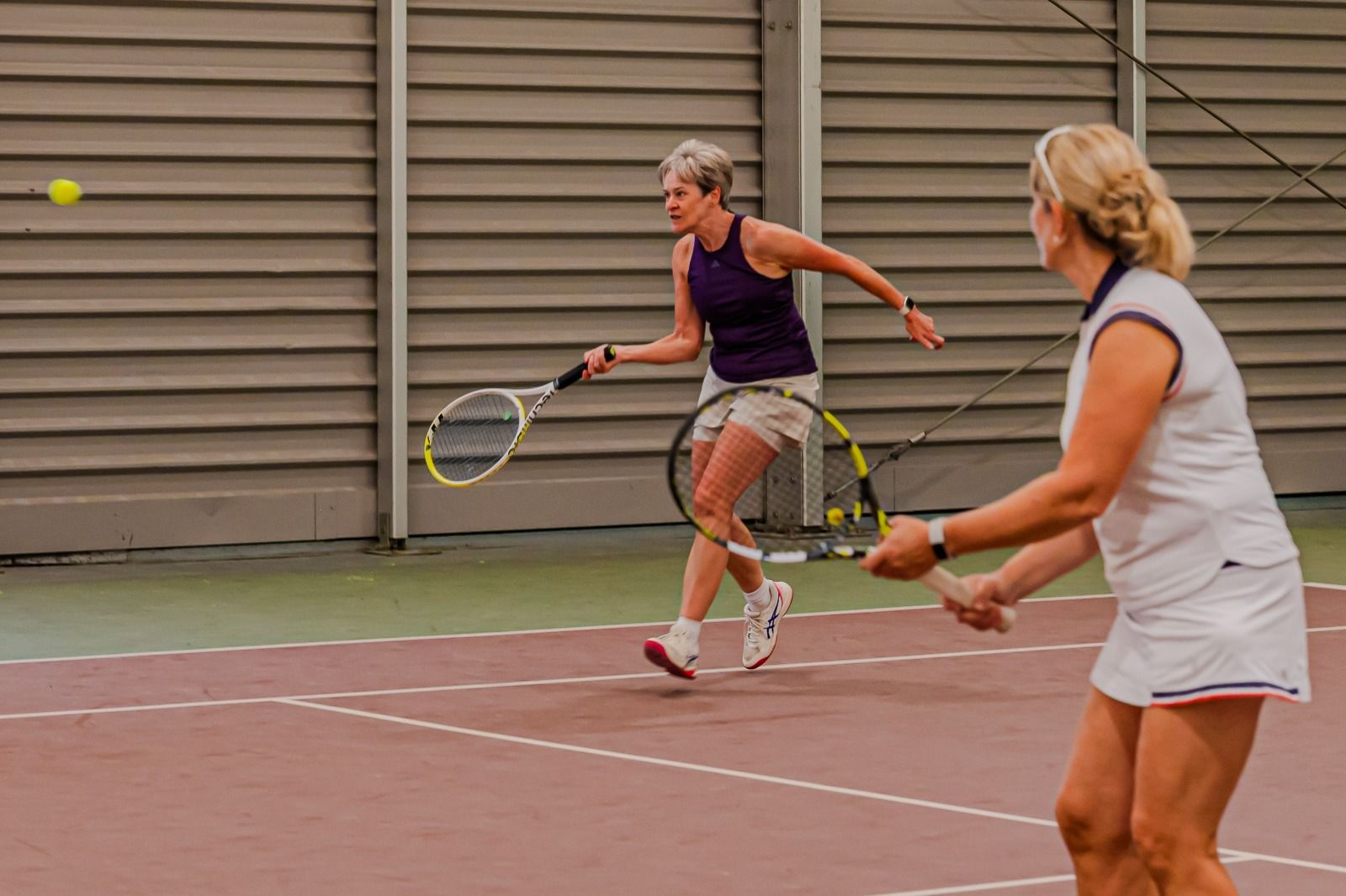 Doubles players in action on the indoor courts