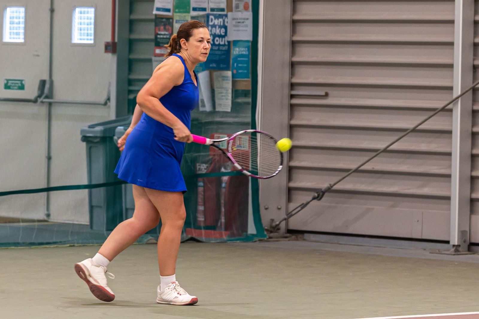 Player stepping into a forehand on the indoor courts at War Memorial Park
