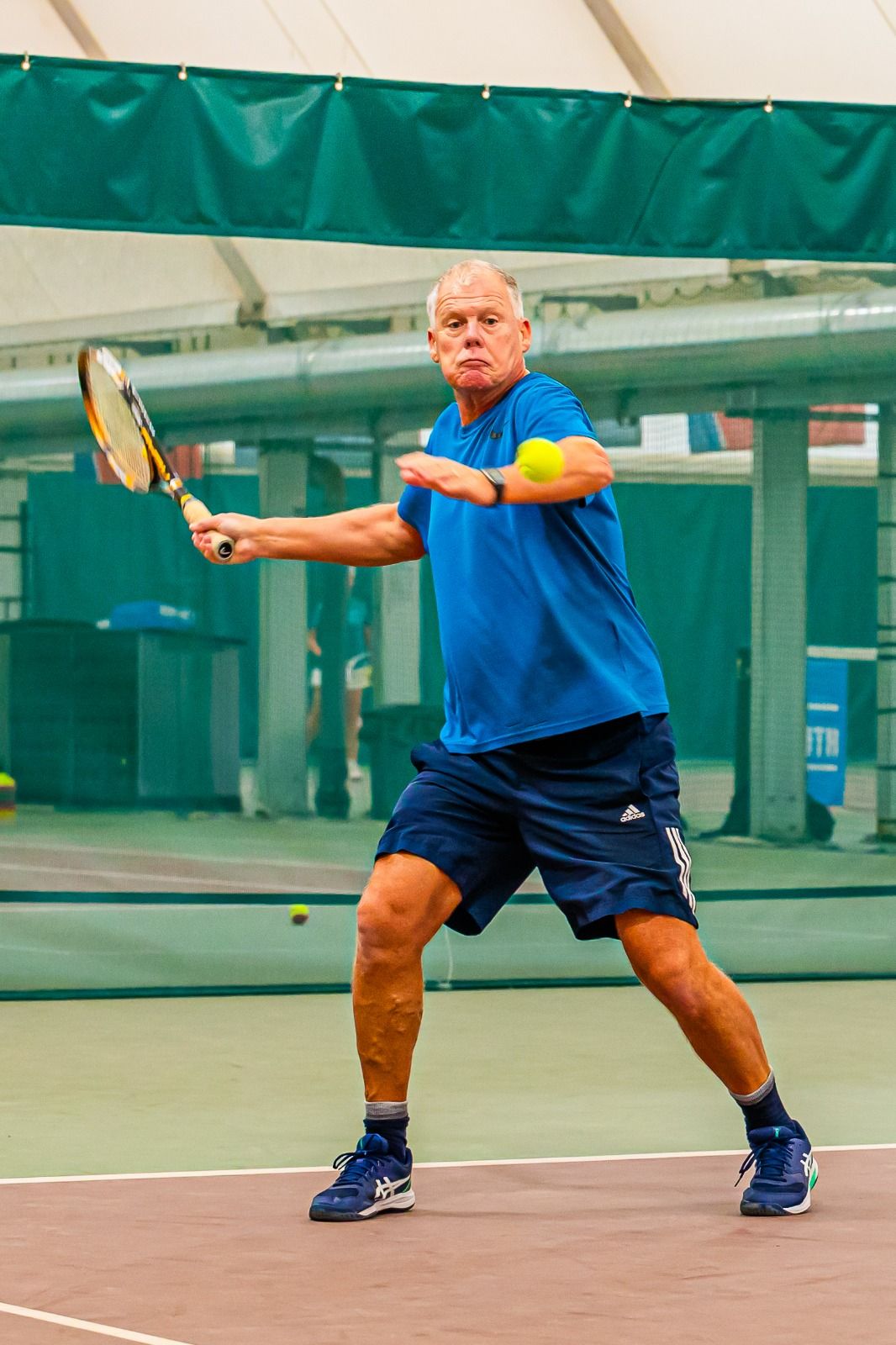 Player lining up a forehand on the indoor courts