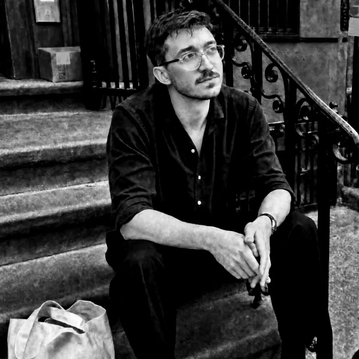 Max sitting on a brownstone stoop.