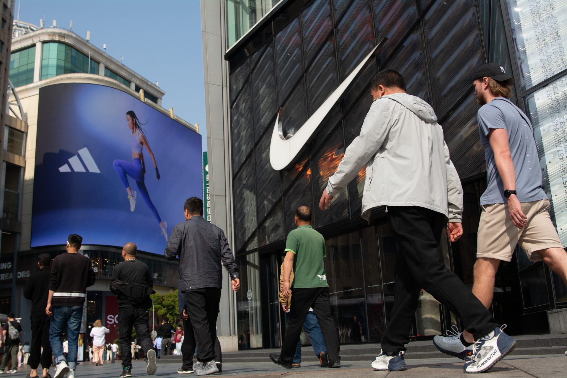 Tourists walk in front of a Nike retail store in Shanghai, China, on April 6, 2025. The US sportswear giant is opening a new in-house production studio in the city to drive local content creation as part of its long-term China growth strategy. Image for THE GOODS VIA Getty Images