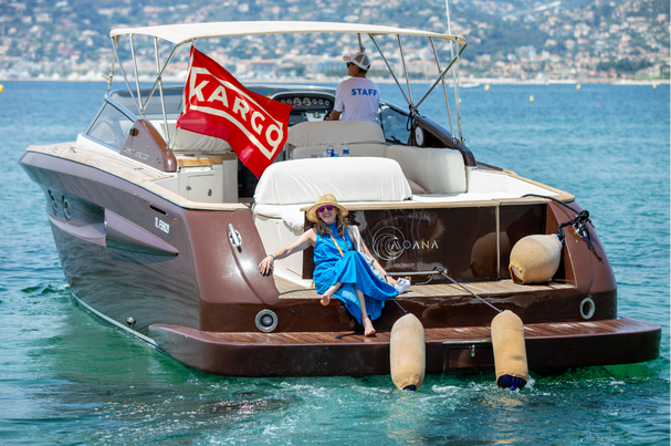 Kargo-branded boat on the water at Cannes Lions, with a guest seated on the back