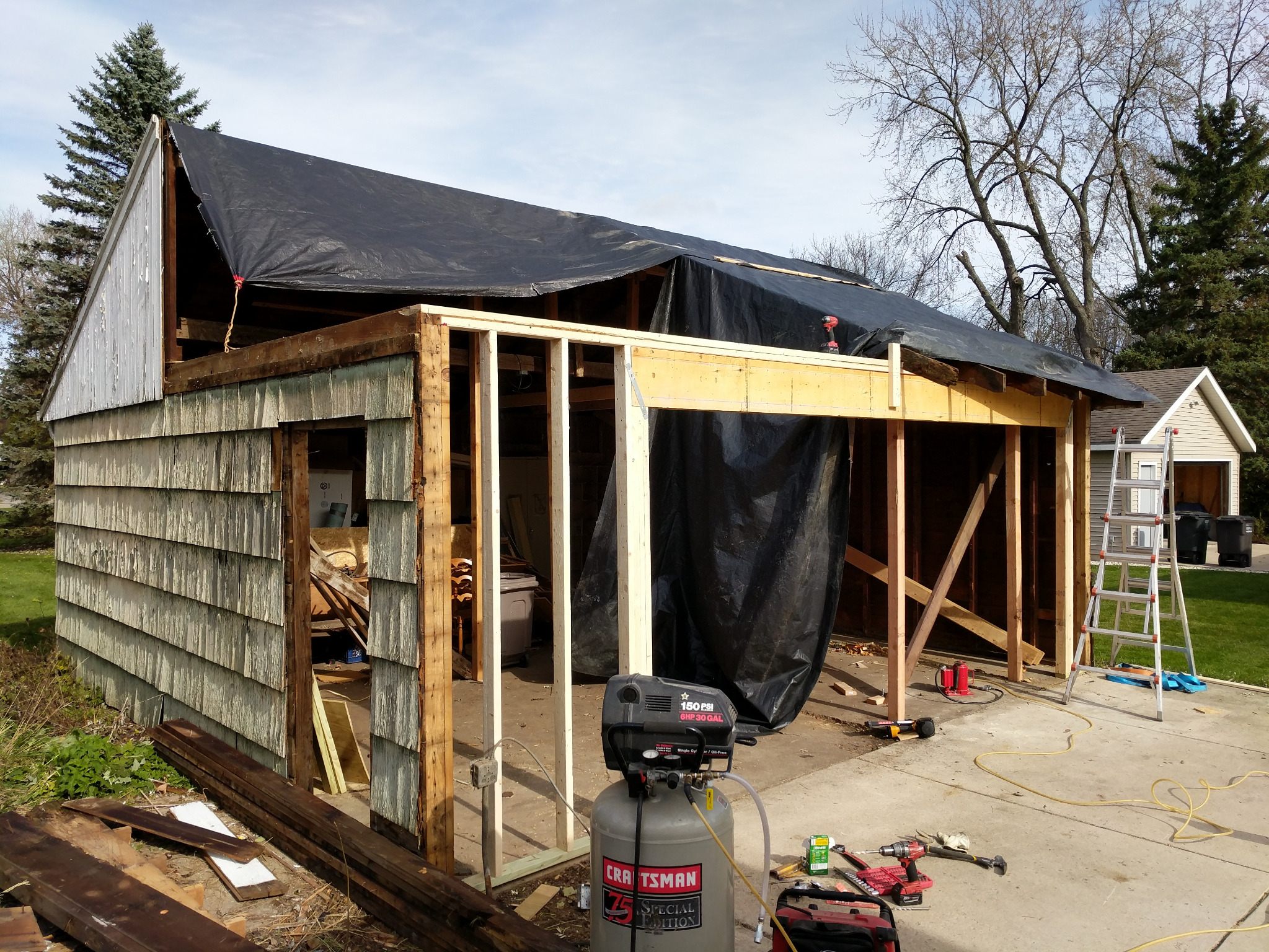 Oconomowoc garage framing exposed during structural roof and perimeter repairs.