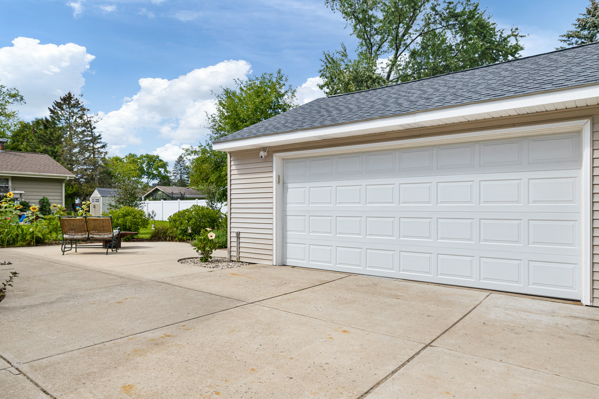 Oconomowoc garage exterior after structural repairs, with new door, siding and roof.