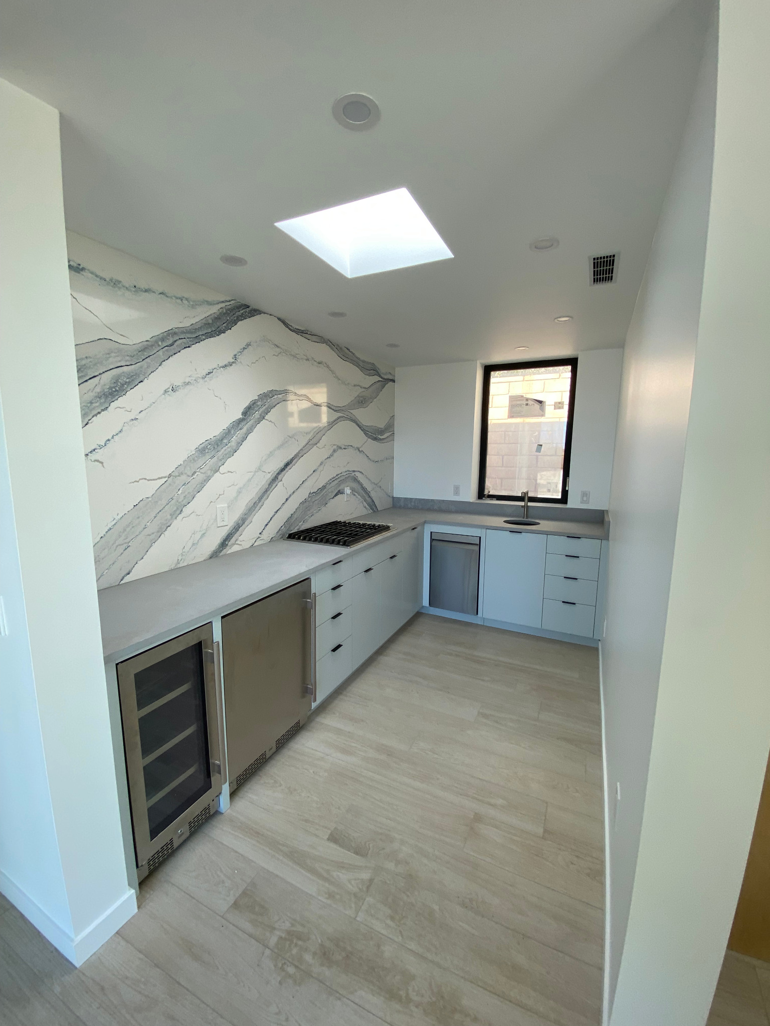 Rancho Mirage casita kitchen with skylight and stone-pattern backsplash