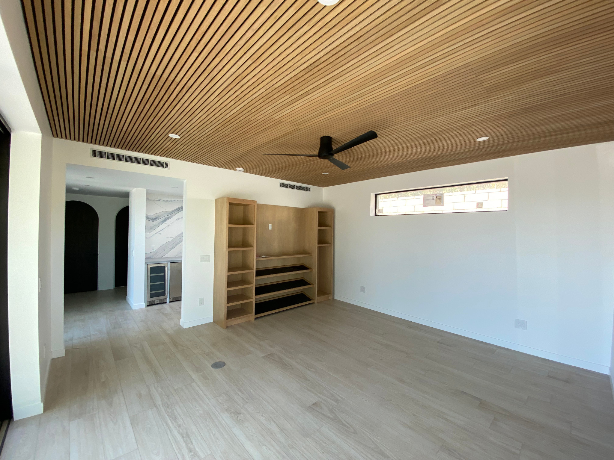 Rancho Mirage casita living room with wood slat ceiling and built-in shelving