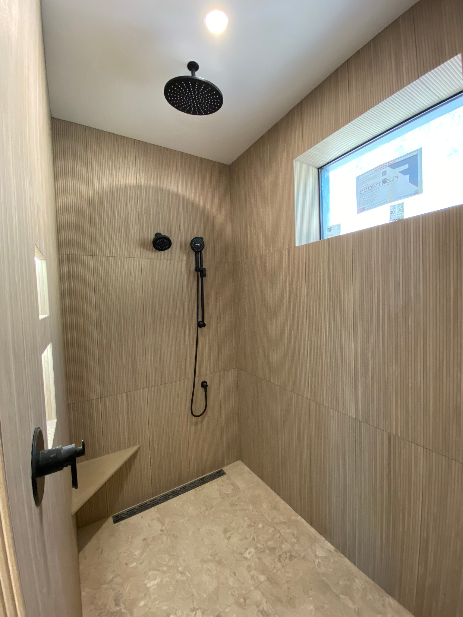 Rancho Mirage casita walk-in shower with wood-look tile and black fittings