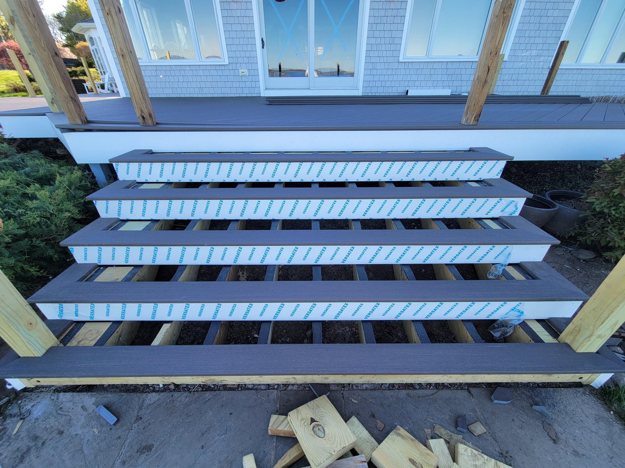 New deck stairs and PVC decking installation in progress.