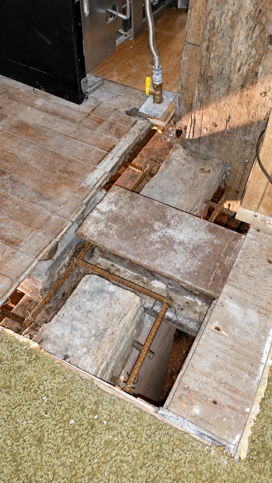 A close view of floor and timber-post work during the structural repair.