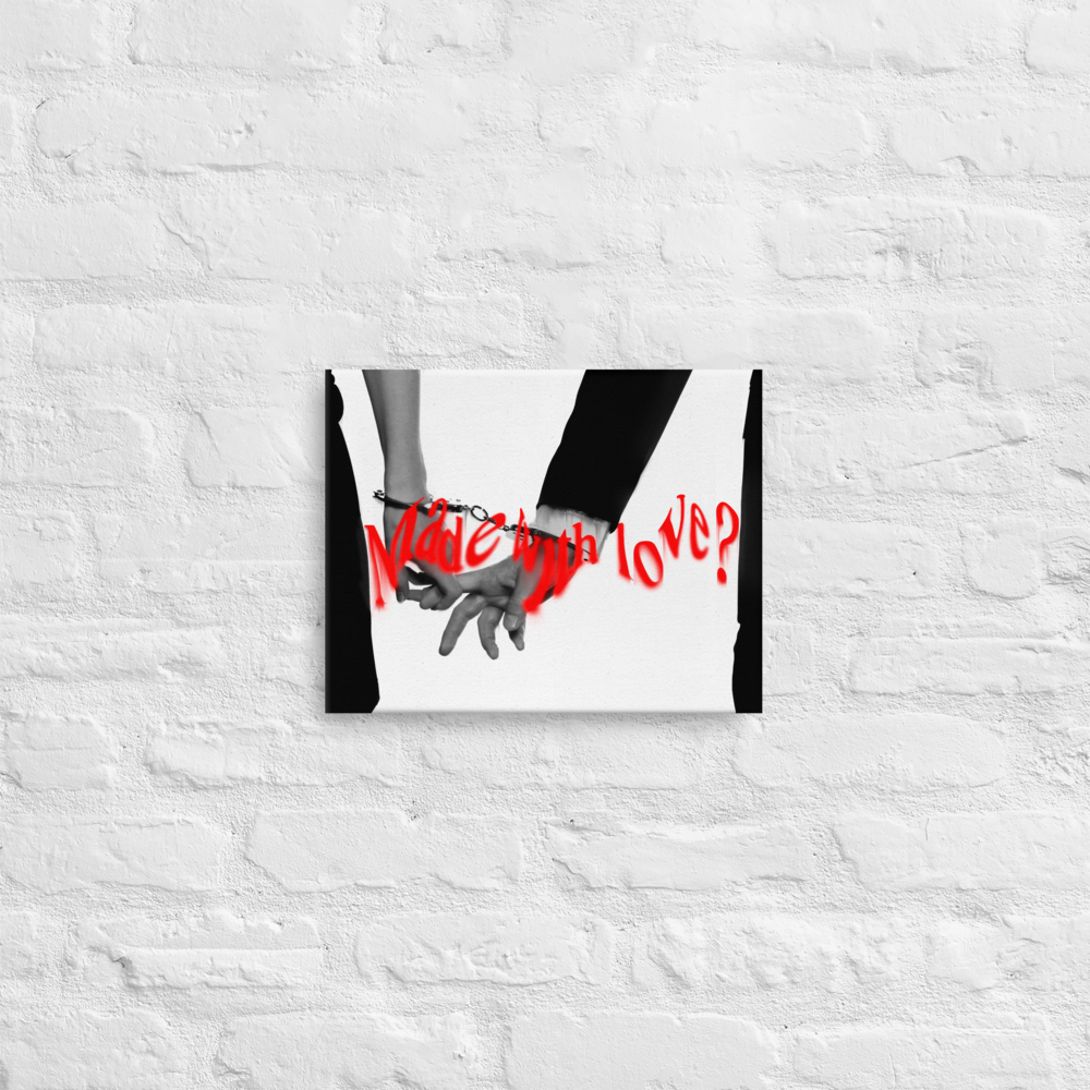 A stark black-and-white photo features two figures—one in a dress, one in a suit—holding pinkies, their hands bound together by a single pair of handcuffs. Centered across the image, in bold red spray-paint, the phrase “Made with love?” cuts through the monochrome like a challenge, not a declaration.