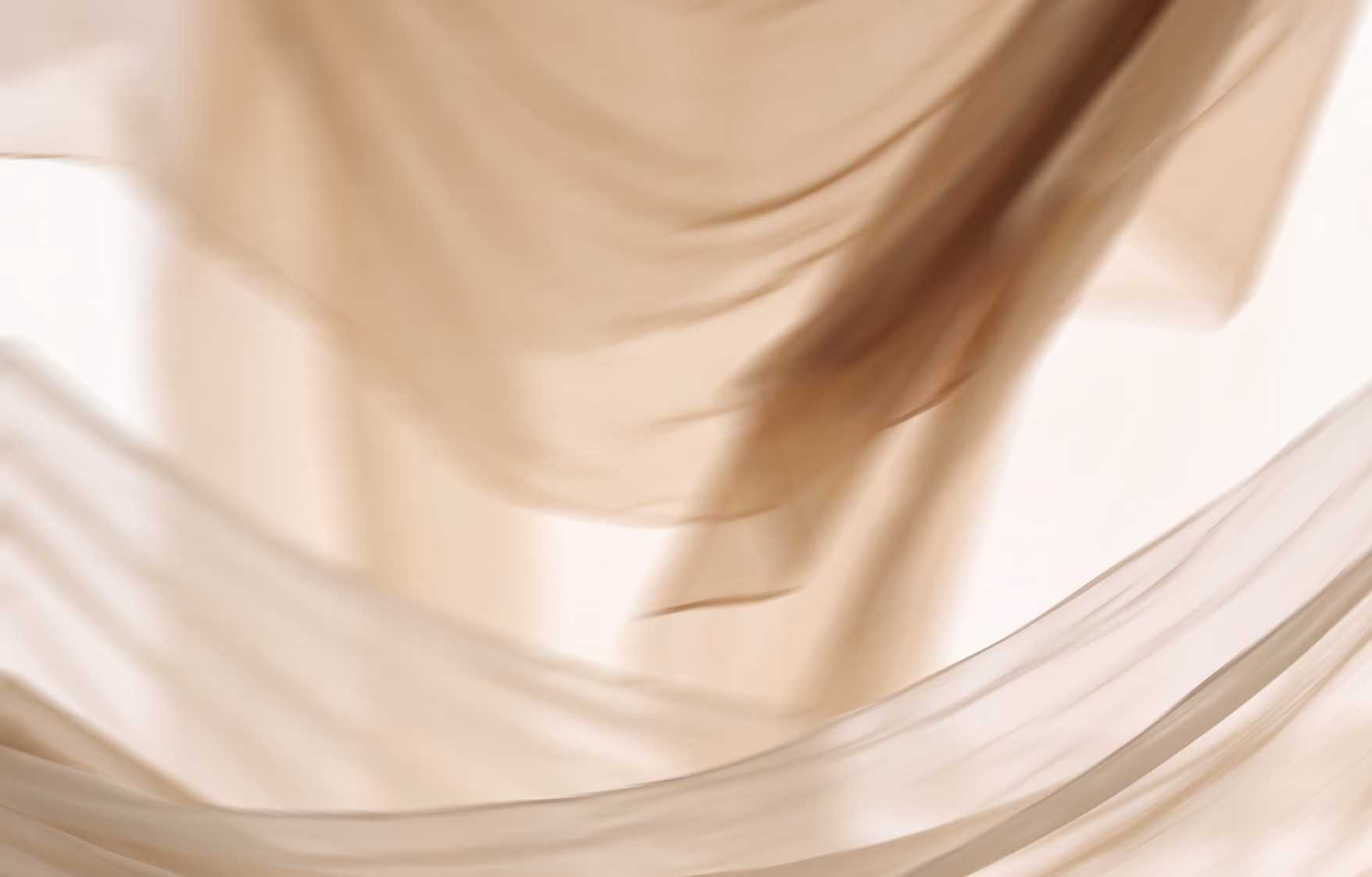 Light beige translucent fabric flowing softly with gentle folds and curves.