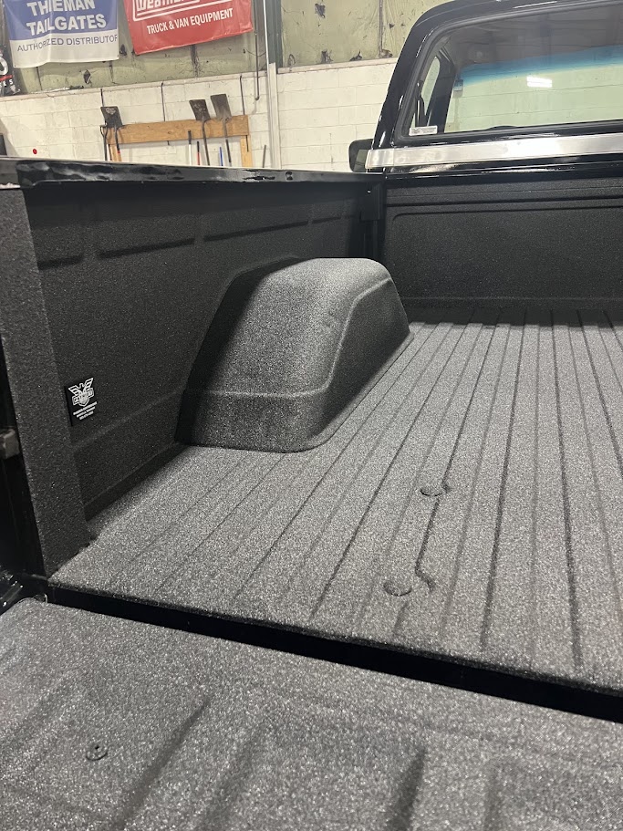 Pickup truck bed coated with a textured spray-in bedliner