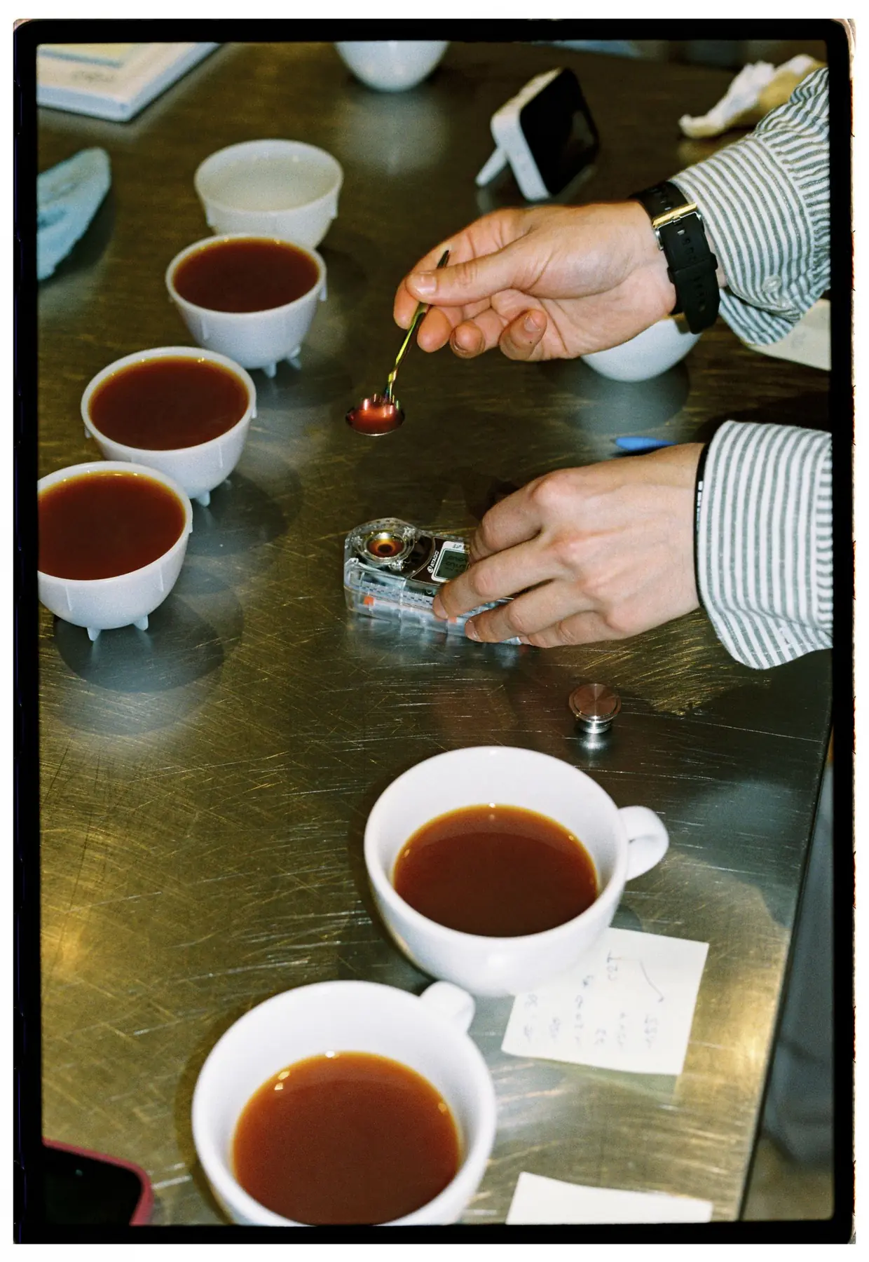 Coffee cupping with tasting bowls and a spoon